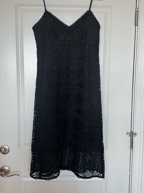 Black lined lace dress.